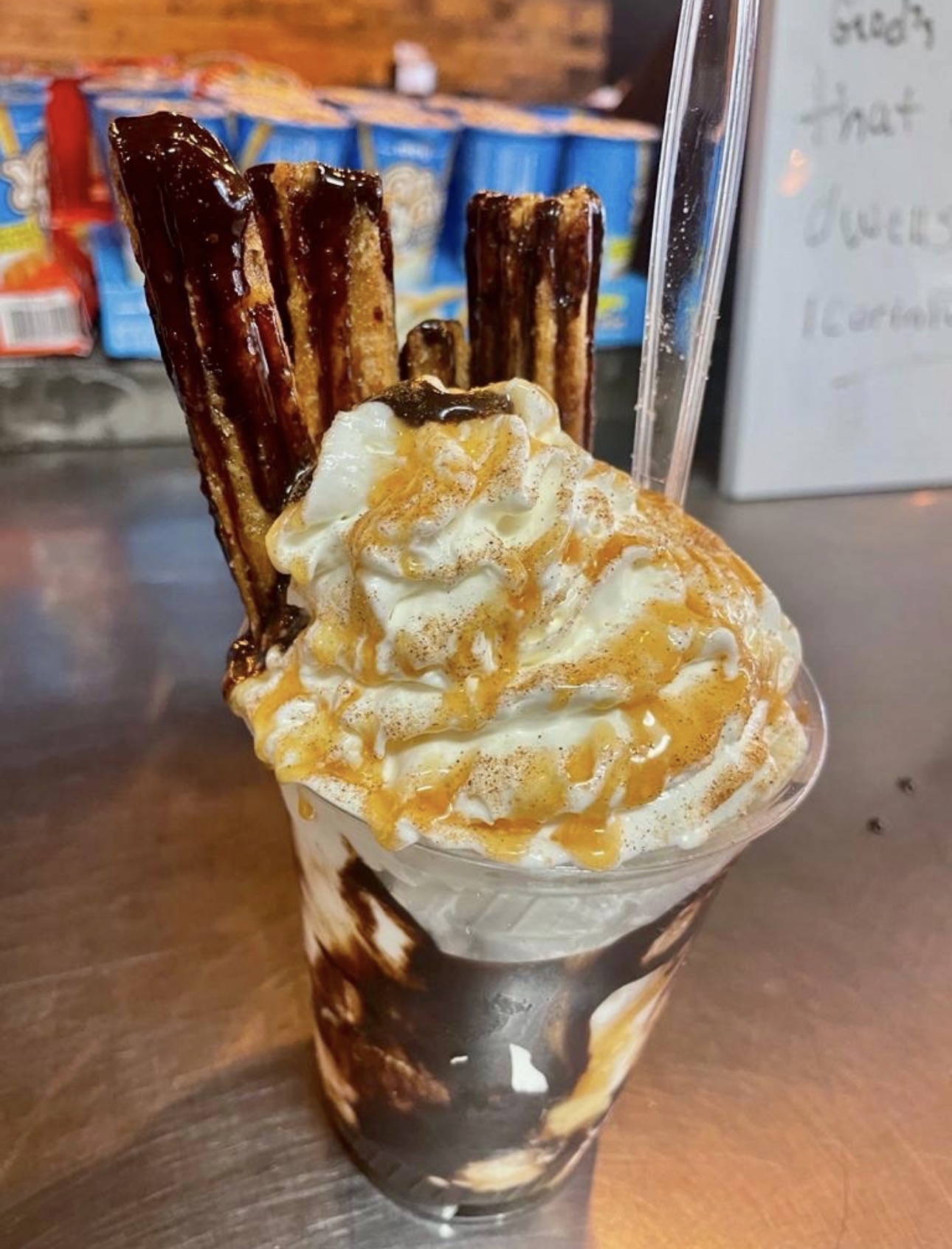 Churro sundae with whipped cream, caramel and chocolate drizzle