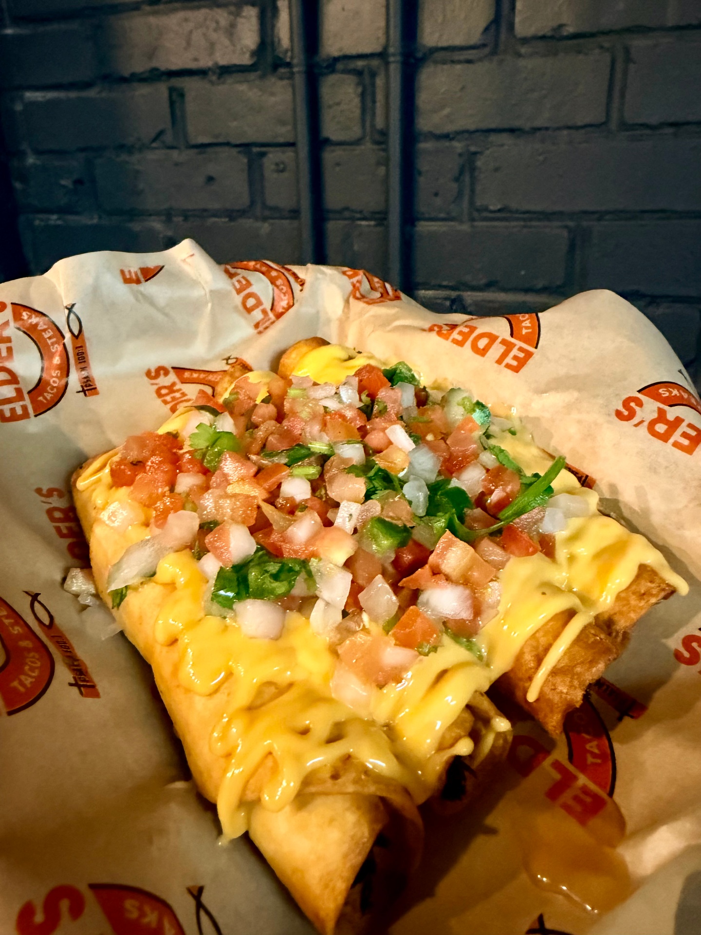 Crispy flautas topped with queso, pico de gallo and cilantro